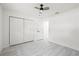 Bright bedroom with light grey flooring, ceiling fan, closet and a white door at 4410 Lurline Cir, Tampa, FL 33610