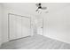 Bright bedroom features a ceiling fan, closet and neutral paint, offering a serene and adaptable space at 4410 Lurline Cir, Tampa, FL 33610
