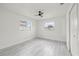 Bright bedroom features gray wood-look floors and two windows at 4410 Lurline Cir, Tampa, FL 33610