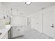 Open concept kitchen features white cabinets and stone countertops at 4410 Lurline Cir, Tampa, FL 33610