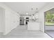 Kitchen with stainless appliances, white cabinets, breakfast bar, and sliding doors to patio at 4410 Lurline Cir, Tampa, FL 33610