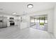 Open kitchen features white cabinets, stainless steel appliances, and sliding door to patio at 4410 Lurline Cir, Tampa, FL 33610