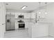 Updated kitchen featuring stainless steel appliances, white cabinets, and breakfast bar at 4410 Lurline Cir, Tampa, FL 33610