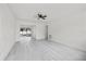 Bright and airy living room with light grey flooring, ceiling fan, and glass sliding doors at 4410 Lurline Cir, Tampa, FL 33610