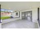 Covered patio with white walls, tile flooring, and sliding glass doors to inside at 4410 Lurline Cir, Tampa, FL 33610