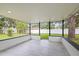 Covered patio with tile flooring and views of the fenced backyard and trees at 4410 Lurline Cir, Tampa, FL 33610