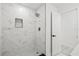 Elegant walk-in shower showcases marble tile, rain shower head, and a built-in niche at 4410 Lurline Cir, Tampa, FL 33610