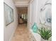 Inviting hallway with light color palette and view into living area at 7814 Hidden Creek Loop # 104, Lakewood Ranch, FL 34202
