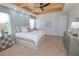 Spacious bedroom with plush bed, ample natural light, and stylish dresser at 7814 Hidden Creek Loop # 104, Lakewood Ranch, FL 34202