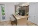 Open kitchen boasts granite countertops and breakfast bar at 7814 Hidden Creek Loop # 104, Lakewood Ranch, FL 34202