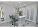 Modern kitchen with white quartz countertops and breakfast bar at 7814 Hidden Creek Loop # 104, Lakewood Ranch, FL 34202