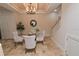 Charming dining area with four chairs and a glass-top table at 7814 Hidden Creek Loop # 104, Lakewood Ranch, FL 34202