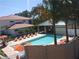 Community pool with lounge chairs and patio area at 7814 Hidden Creek Loop # 104, Lakewood Ranch, FL 34202