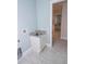 Convenient laundry room with a sink and storage cabinet at 7814 Hidden Creek Loop # 104, Lakewood Ranch, FL 34202