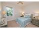 Cozy bedroom with a light blue comforter and plenty of natural light at 7814 Hidden Creek Loop # 104, Lakewood Ranch, FL 34202