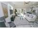 Bright living room showcasing comfortable seating, large windows, and stylish decor at 7814 Hidden Creek Loop # 104, Lakewood Ranch, FL 34202