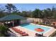 Community pool with lounge chairs and covered patio at 7814 Hidden Creek Loop # 104, Lakewood Ranch, FL 34202