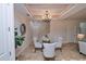 Elegant dining room features a glass table and chandelier at 7814 Hidden Creek Loop # 104, Lakewood Ranch, FL 34202