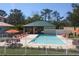 Community pool with lounge chairs and a covered patio area at 7780 Hidden Creek Loop # 101, Lakewood Ranch, FL 34202