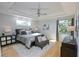 Spacious bedroom with hardwood floors and a cozy sitting area at 7780 Hidden Creek Loop # 104, Lakewood Ranch, FL 34202