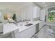 Modern kitchen with white cabinets, quartz countertops and stainless steel appliances at 7780 Hidden Creek Loop # 104, Lakewood Ranch, FL 34202