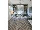 Bright home office features built-in shelving, hardwood floors, and a large desk at 7780 Hidden Creek Loop # 104, Lakewood Ranch, FL 34202