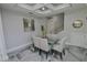 Elegant dining room with a glass-top table and modern lighting at 7780 Hidden Creek Loop # 104, Lakewood Ranch, FL 34202