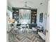 Spacious home office with built-in shelving and hardwood floors at 7780 Hidden Creek Loop # 104, Lakewood Ranch, FL 34202