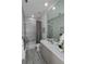 Modern bathroom with a shower/tub combo, vanity, and grey tile at 7780 Hidden Creek Loop # 104, Lakewood Ranch, FL 34202
