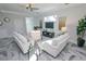 Relaxing living room with comfortable sofas and a large flat-screen TV at 7780 Hidden Creek Loop # 104, Lakewood Ranch, FL 34202