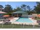 Community pool with patio and seating at 7780 Hidden Creek Loop # 104, Lakewood Ranch, FL 34202