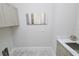 Well-lit laundry room with cabinets and countertop at 7780 Hidden Creek Loop # 104, Lakewood Ranch, FL 34202