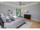 Main bedroom with hardwood floors and access to a private balcony at 7780 Hidden Creek Loop # 104, Lakewood Ranch, FL 34202