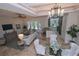 Open living room and kitchen with high ceilings and neutral colors at 7730 Hidden Creek Loop # 102, Lakewood Ranch, FL 34202