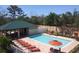 Community pool and patio with plenty of lounge chairs at 7730 Hidden Creek Loop # 102, Lakewood Ranch, FL 34202