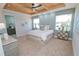 Spacious main bedroom with carpeted floor and en-suite bathroom at 7730 Hidden Creek Loop # 102, Lakewood Ranch, FL 34202