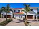 Modern two-story home with two car garage and palm trees at 7730 Hidden Creek Loop # 102, Lakewood Ranch, FL 34202