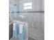 Walk-in shower with glass enclosure and tiled walls at 7730 Hidden Creek Loop # 102, Lakewood Ranch, FL 34202