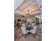 Bright dining area with a glass-top table and modern chandelier at 7730 Hidden Creek Loop # 102, Lakewood Ranch, FL 34202