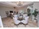 Open concept dining room with a glass table and chandelier at 7730 Hidden Creek Loop # 102, Lakewood Ranch, FL 34202