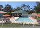 Community pool with lounge chairs and covered seating at 7730 Hidden Creek Loop # 102, Lakewood Ranch, FL 34202