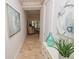 Elegant hallway with light tile flooring and art at 7730 Hidden Creek Loop # 102, Lakewood Ranch, FL 34202