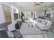 Bright living room with white sofas and large windows at 7834 Hidden Creek Loop # 104, Lakewood Ranch, FL 34202