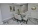 Elegant dining room with glass table and six modern chairs at 7834 Hidden Creek Loop # 104, Lakewood Ranch, FL 34202