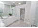 Elegant bathroom with double vanity, walk-in shower, and separate toilet at 7834 Hidden Creek Loop # 104, Lakewood Ranch, FL 34202