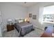 Bright bedroom with gray carpet, double bed, and built-in desk at 7834 Hidden Creek Loop # 104, Lakewood Ranch, FL 34202