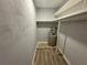 Small laundry closet with shelving and water heater at 5380 4Th N St # 203, St Petersburg, FL 33703