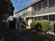 Building exterior showcasing landscaping and walkway at 5380 4Th N St # 203, St Petersburg, FL 33703