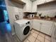 White kitchen cabinets, wood-look floors, and a stackable washer/dryer at 5380 4Th N St # 203, St Petersburg, FL 33703