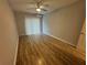Large bedroom with wood-look floors and ceiling fan at 5380 4Th N St # 203, St Petersburg, FL 33703